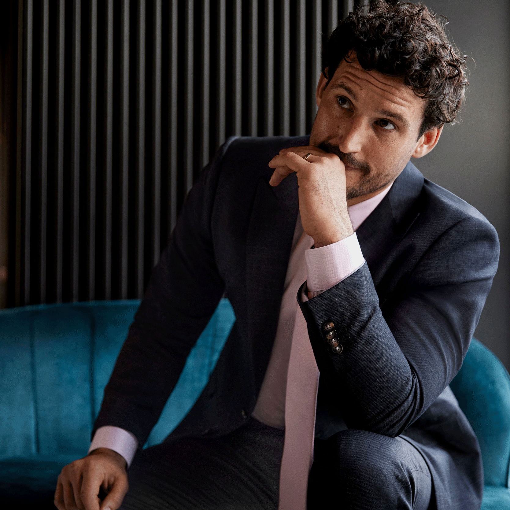 Fit for every emotion Model wearing POLITIX Charcoal suit looking emotional for his wedding day