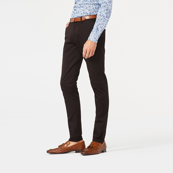 Model wearing a green polo short sleeve shirt Model wearing dark brown ultra slim winsor chino with blue floral shirtt
