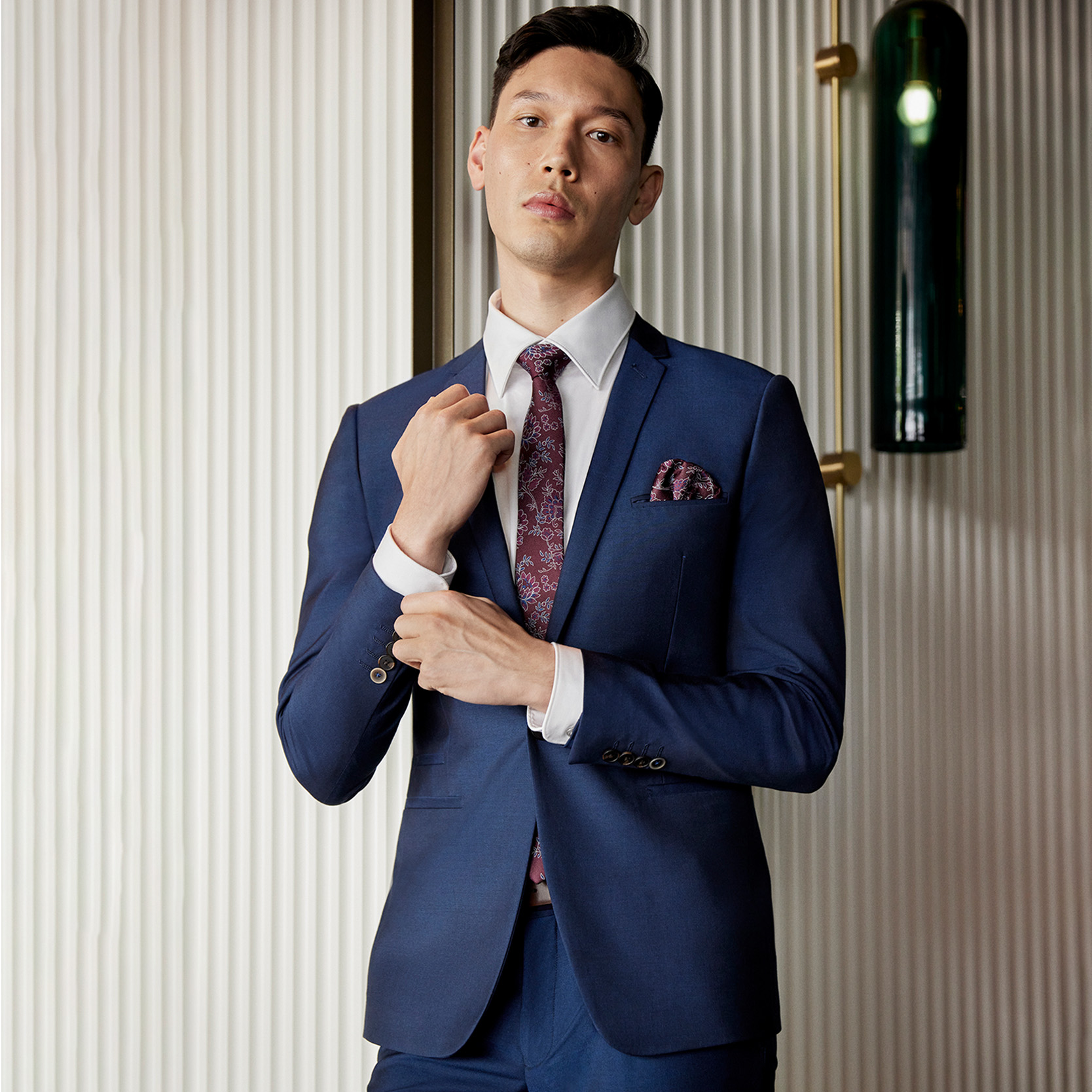 A classic for keeping your cool. Model wearing Grey POLITIX Navy suit reaching for cuff