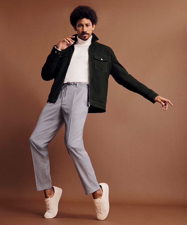 Outfit featuring urban dark green statement jacket Model wearing POLITIX white roll neck with urban dark green statement jacket