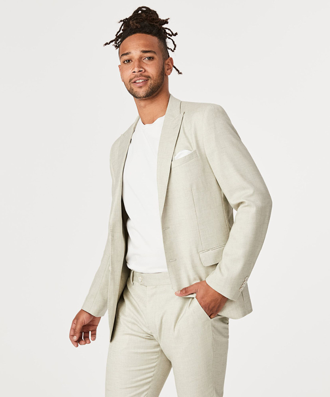 Featuring a crisp two-piece suit in off-white, coupled with a pristine white tee.