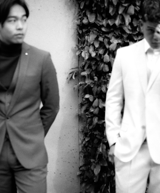 Gnomeboys featuring POLITIX Black and white image og Mike and Nathan wearing POLITIX suits in front of concrete and leafy background