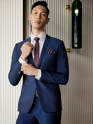 Groom wearing formal wedding suit pant and suit jacket.