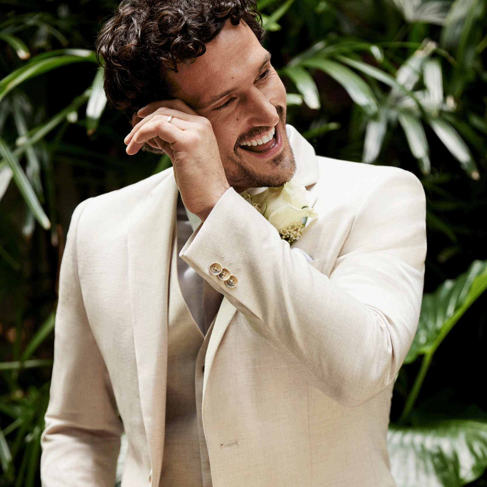 Neutral tone. Happy groom. Model wearing fawn suit smiling and happy