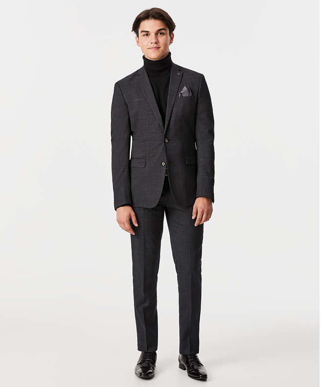 Harvey Petito wearing charcoal suit and no bow tie