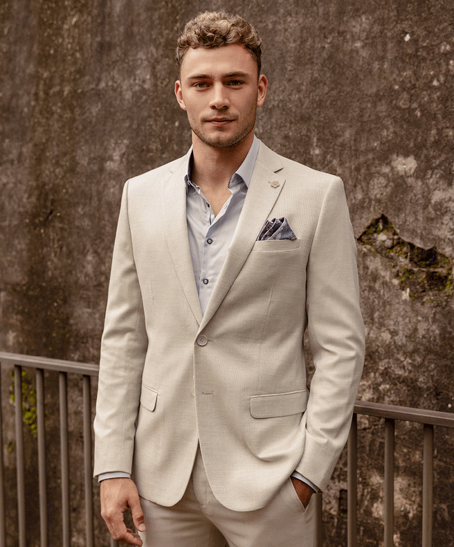 Will Hayward featuring POLITIX Gif of Will Hayward wearing cream suit and blue button up shirt