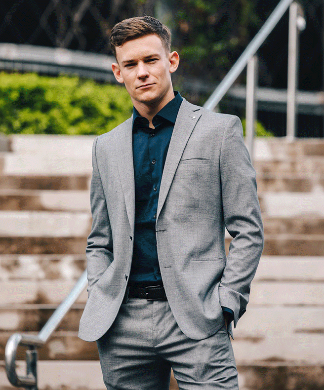 Thomas Maxwell featuring POLITIX Images of Thomas Maxwell in POLITIX dark grey suit smiling next to racecar in Monte Carlo
